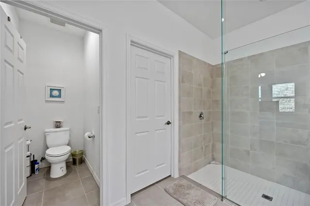 a bathroom with a toilet a sink and shower