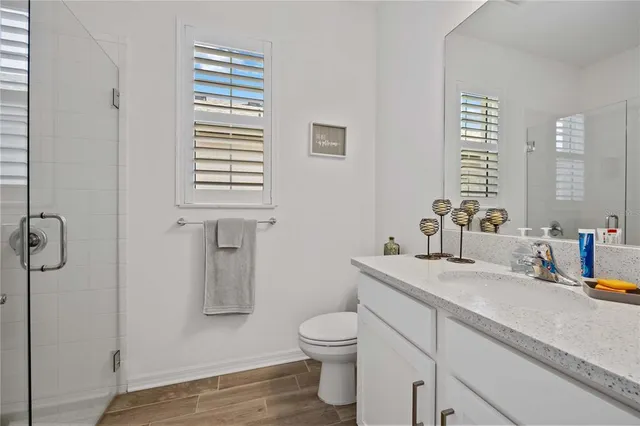 a bathroom with a sink toilet and shower
