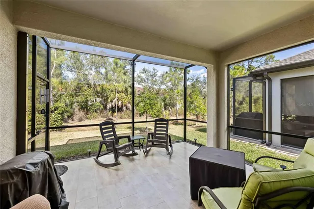 a living room with furniture and a floor to ceiling window
