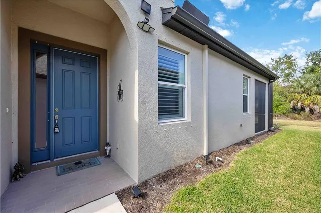 a view of backyard with potted plants and wooden fence