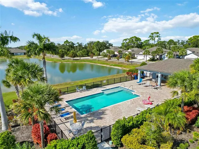 an aerial view of a house with a lake view and a yard