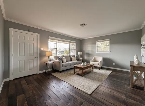 a living room with furniture and wooden floor