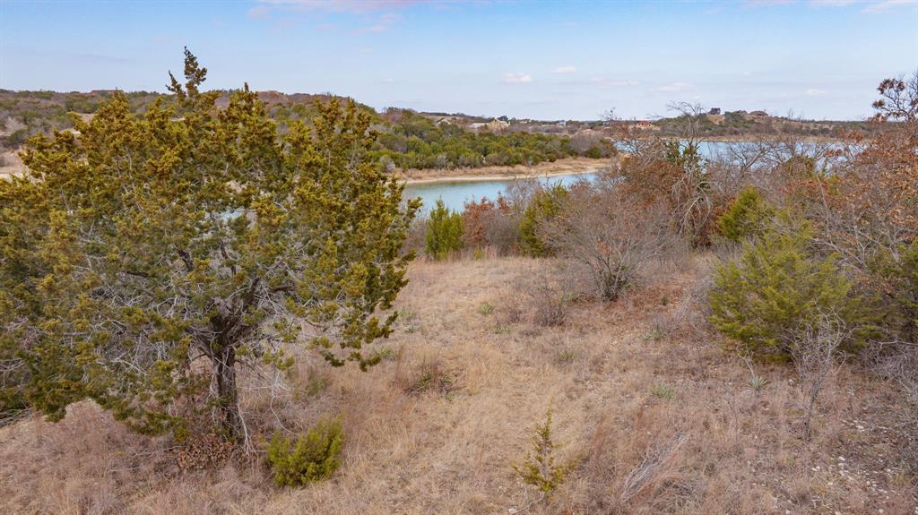 915 Anchor Way Bluff Dale, TX 76433 - Photo 16 of 37 a view of a lake with a mountain in the background