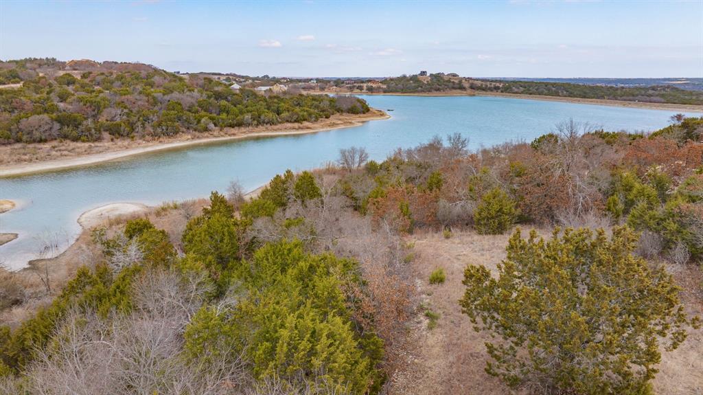 915 Anchor Way Bluff Dale, TX 76433 - Photo 17 of 37 a view of a lake with a mountain in the background