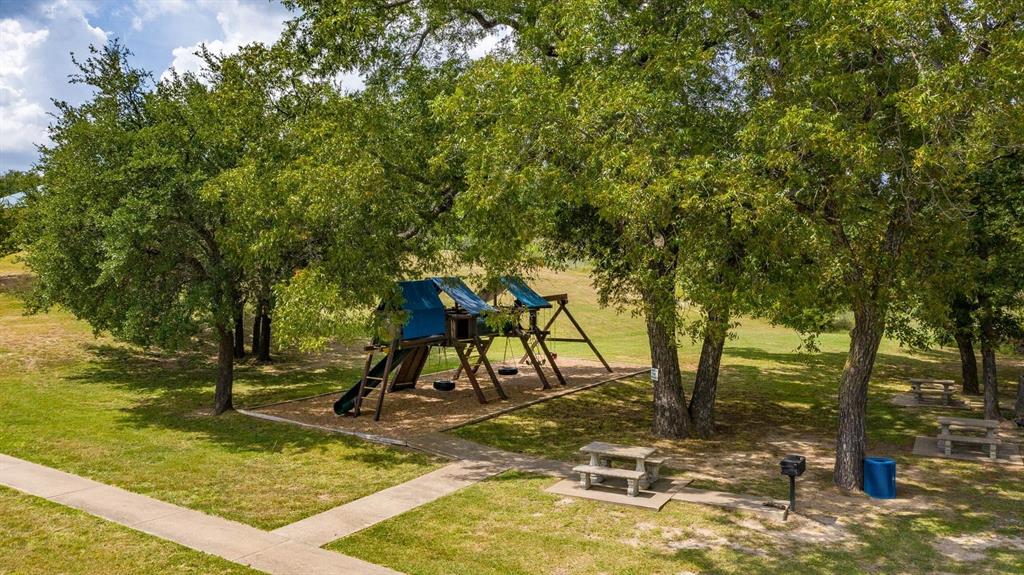 915 Anchor Way Bluff Dale, TX 76433 - Photo 24 of 37 a view of swimming pool with lawn chairs and large trees