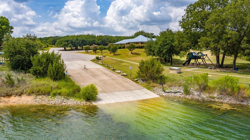 915 Anchor Way Bluff Dale, TX 76433 - Photo 25 of 37 a view of a lake with a yard
