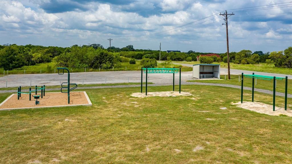 915 Anchor Way Bluff Dale, TX 76433 - Photo 35 of 37 a view of a swimming pool with a house in the background