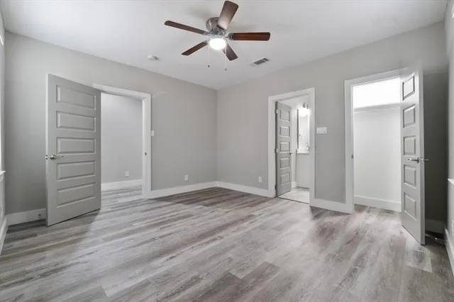 a bathroom with a granite countertop toilet a sink and shower