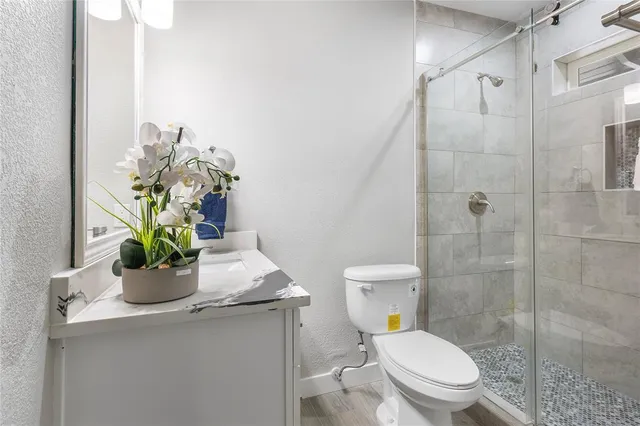 a view of a balcony with wooden floor and fence