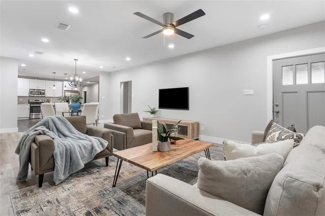 a living room with furniture and a flat screen tv