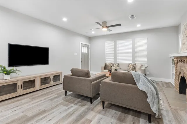 a view of a dining room with furniture a chandelier and wooden floor