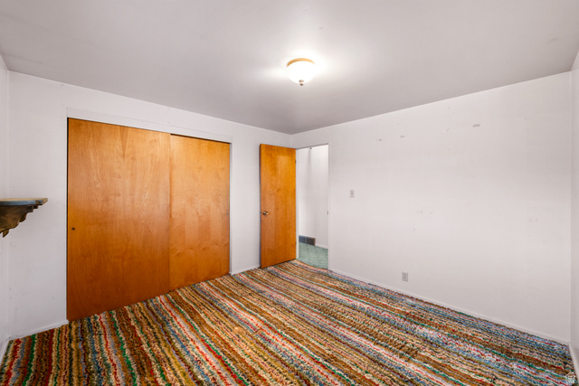 1940 West Old Hwy Road Morgan, UT 84050 - Photo 34 of 73 Room featuring a colorful striped carpet, light wood-finish sliding closet doors, and white painted walls