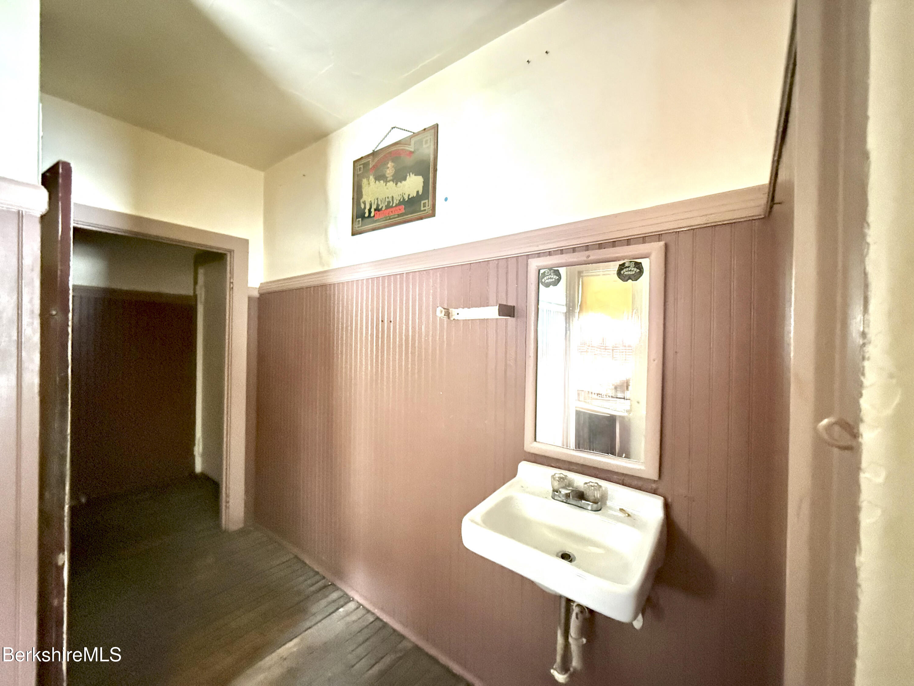 9 Depot Street Monroe, MA 01350 - Photo 14 of 30 a bathroom with a sink a mirror and a window