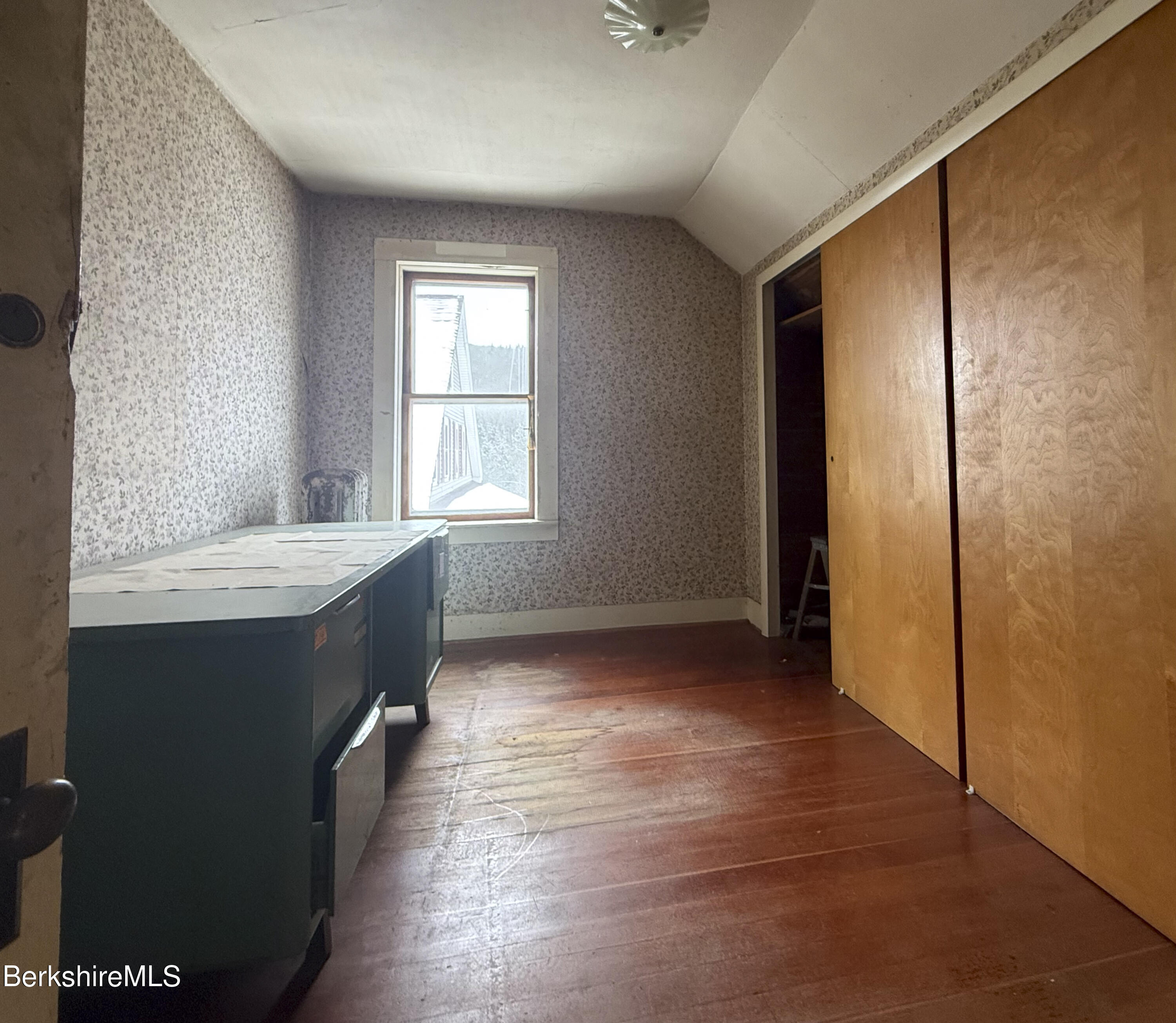 9 Depot Street Monroe, MA 01350 - Photo 8 of 30 an empty room with wooden floor and windows