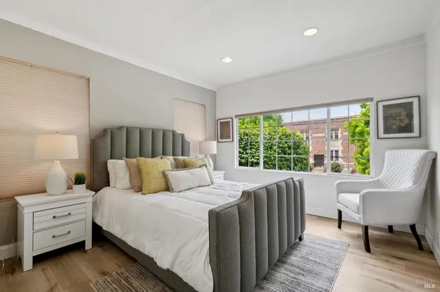 a bedroom with a bed and a large window