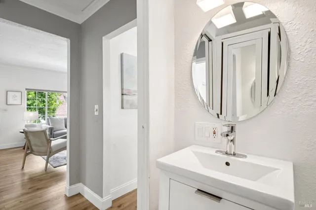 a bathroom with a sink mirror and toilet