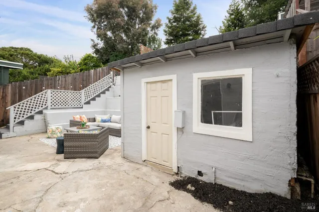 a backyard of a house with table and chairs