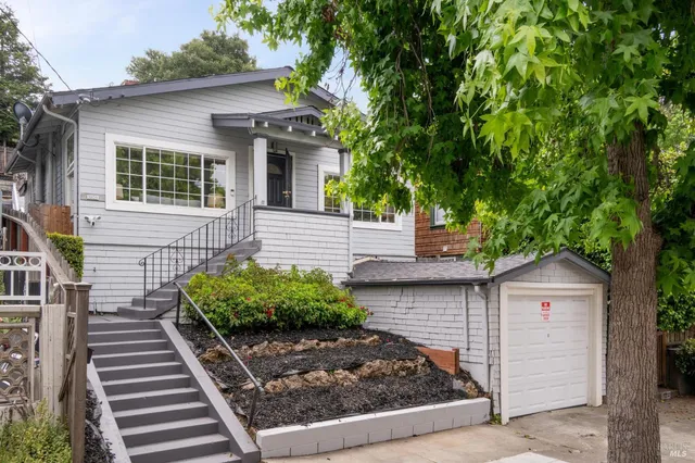 a living room with a fireplace and a potted plant