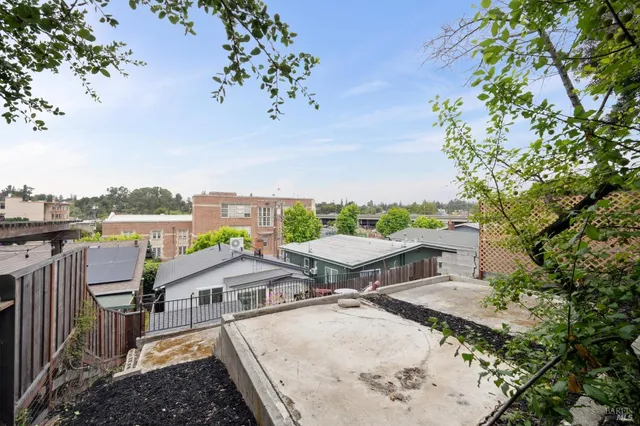 a view of a patio with a table and chairs