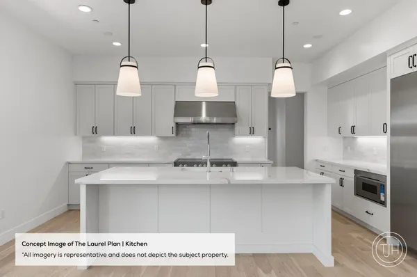 a large kitchen with stainless steel appliances kitchen island a large island in it