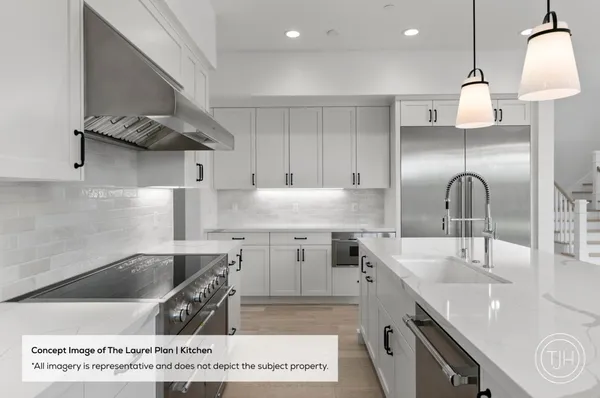 a kitchen with kitchen island granite countertop a sink a counter space appliances and cabinets