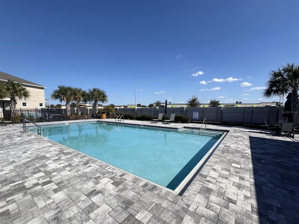 1025 Spring Palms Loop Orlando, FL 32828 - Photo 5 of 9 a view of a swimming pool and a yard