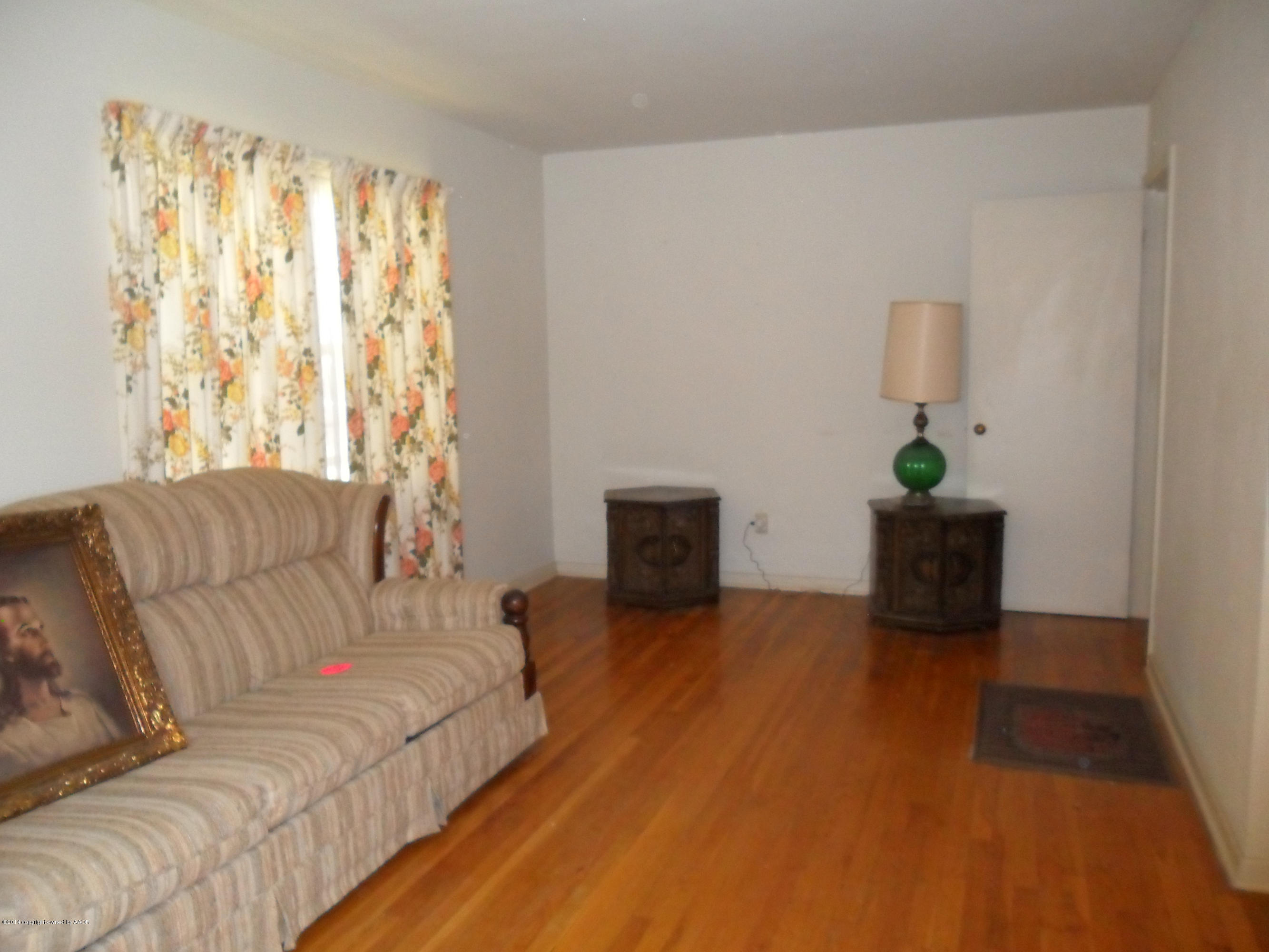 4606 Preston Street Amarillo, TX 79110 - Photo 2 of 10 a living room with furniture and a fireplace