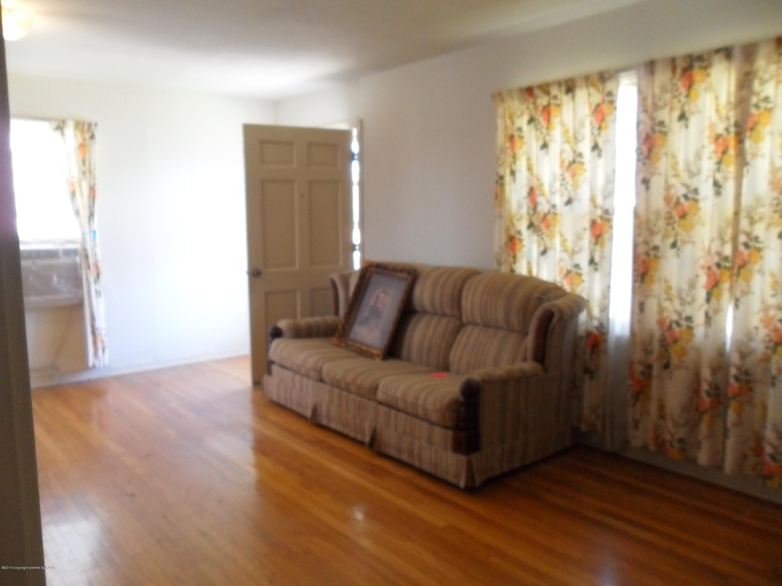 4606 Preston Street Amarillo, TX 79110 - Photo 3 of 10 a living room with furniture and a wooden floor