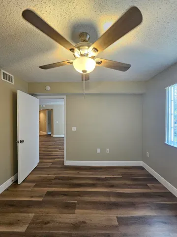a view of room with window and ceiling fan
