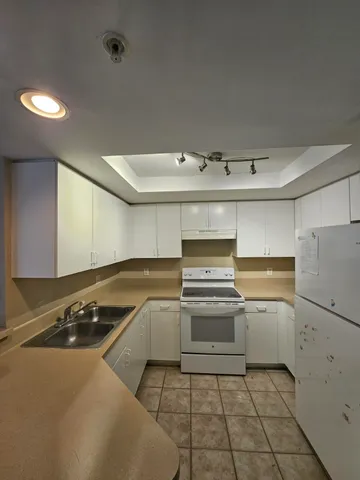 a kitchen with a stove and a refrigerator