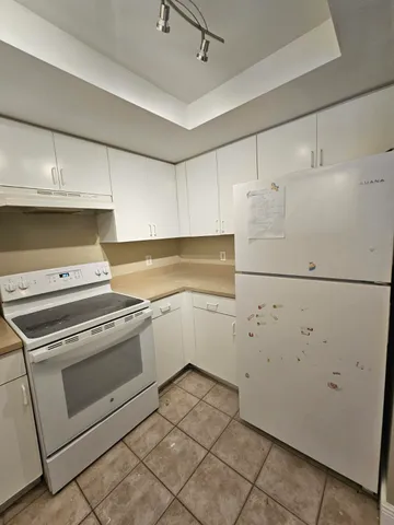 a kitchen with cabinets and appliances