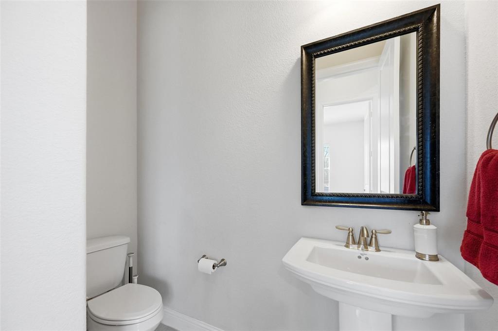 1074 James Court Allen, TX 75013 - Photo 11 of 22 a bathroom with a toilet a sink and mirror