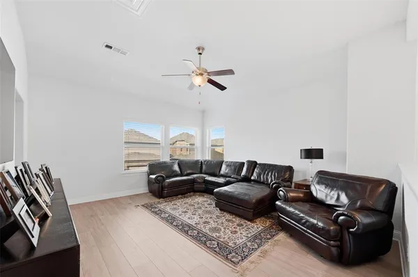a living room with furniture ceiling fan and a rug