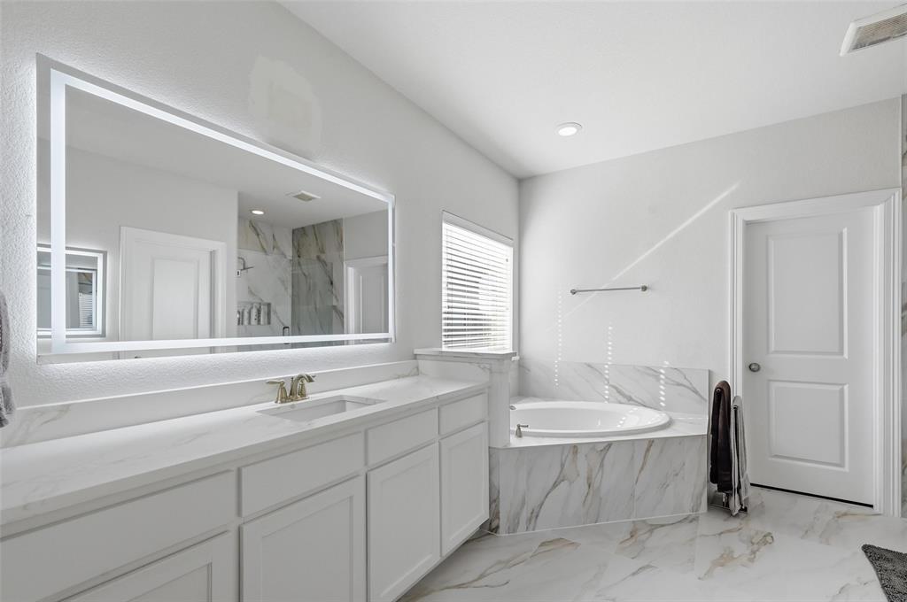 1074 James Court Allen, TX 75013 - Photo 15 of 22 a bathroom with a sink and a bathtub