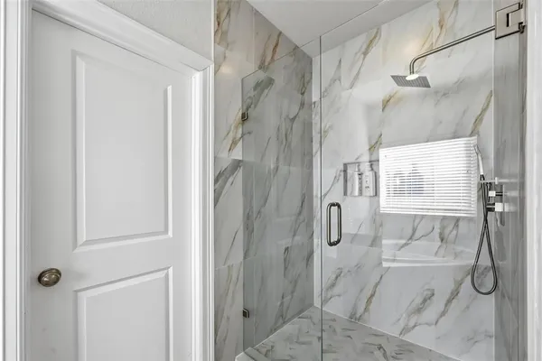 a bathroom with a glass shower door