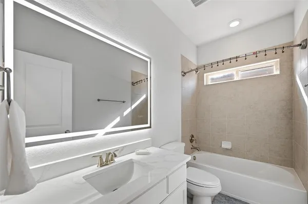 a bathroom with a sink a toilet and a bathtub