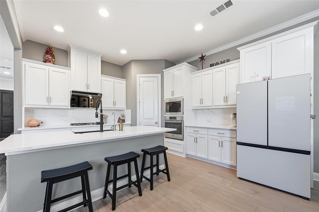 1074 James Court Allen, TX 75013 - Photo 8 of 22 a kitchen with white cabinets and white appliances