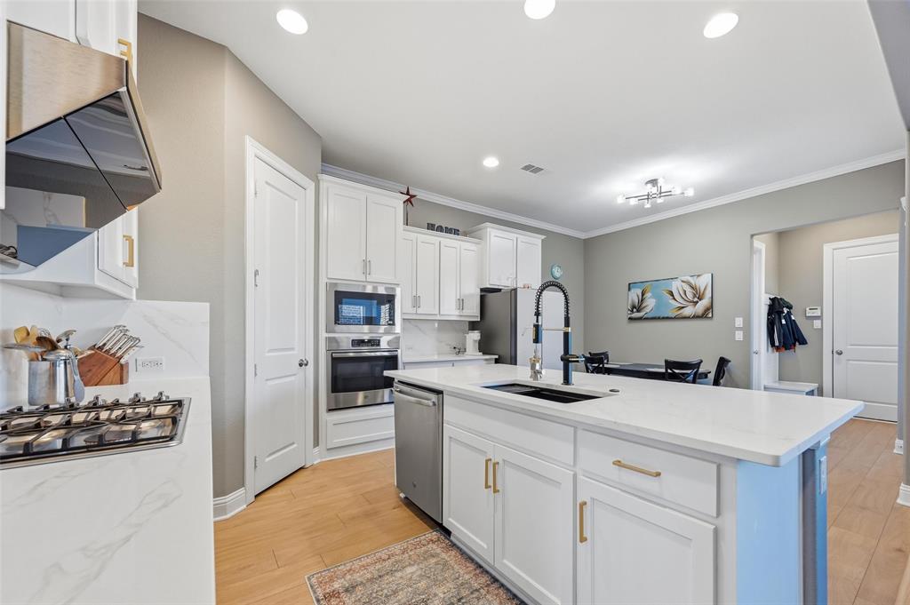 1074 James Court Allen, TX 75013 - Photo 9 of 22 a kitchen with cabinets a sink and appliances