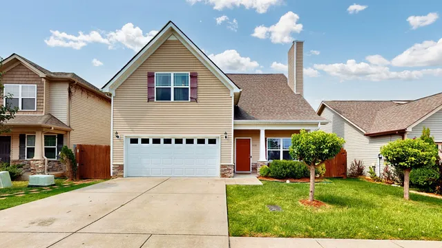 a front view of a house with a yard and garage