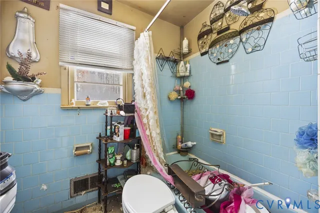 a bedroom with a bed and a mirror