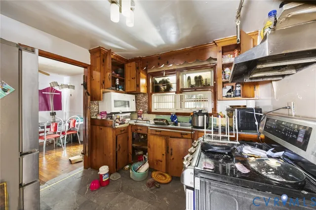 a kitchen with a stove and a refrigerator