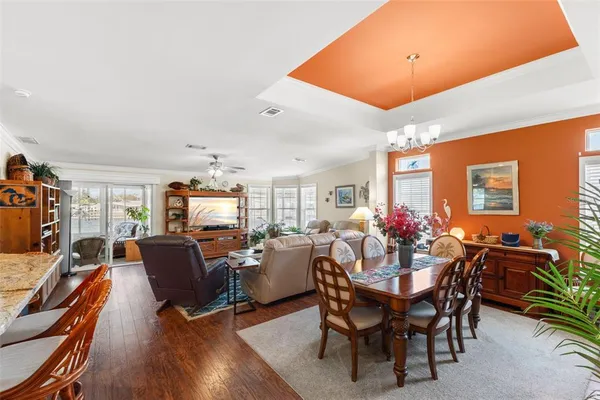 a view of a dining room with furniture and wooden floor