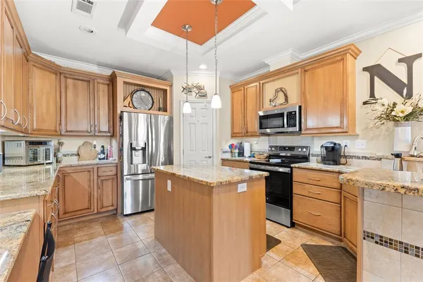 a kitchen with stainless steel appliances granite countertop a stove top oven a sink dishwasher a refrigerator and cabinets with wooden floor