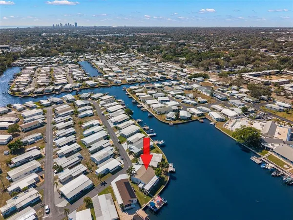 an aerial view of a house with a garden and lake view