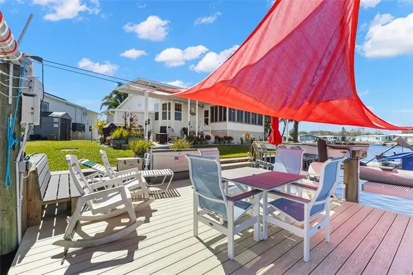 a view of a patio with a table and chairs under an umbrella