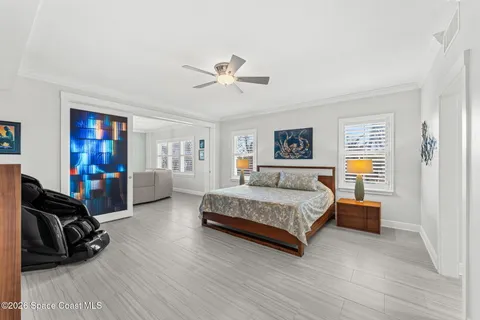 a bedroom with a large bed and a chandelier