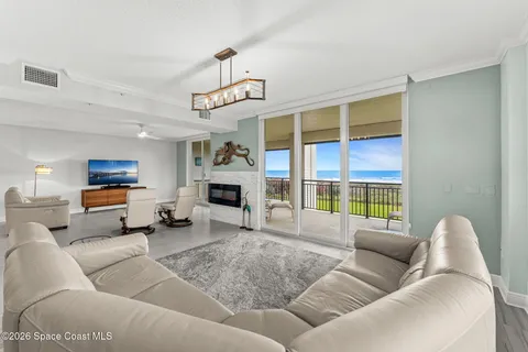 a living room with furniture kitchen view and a window
