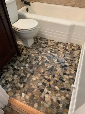 a bathroom with a toilet and a shower