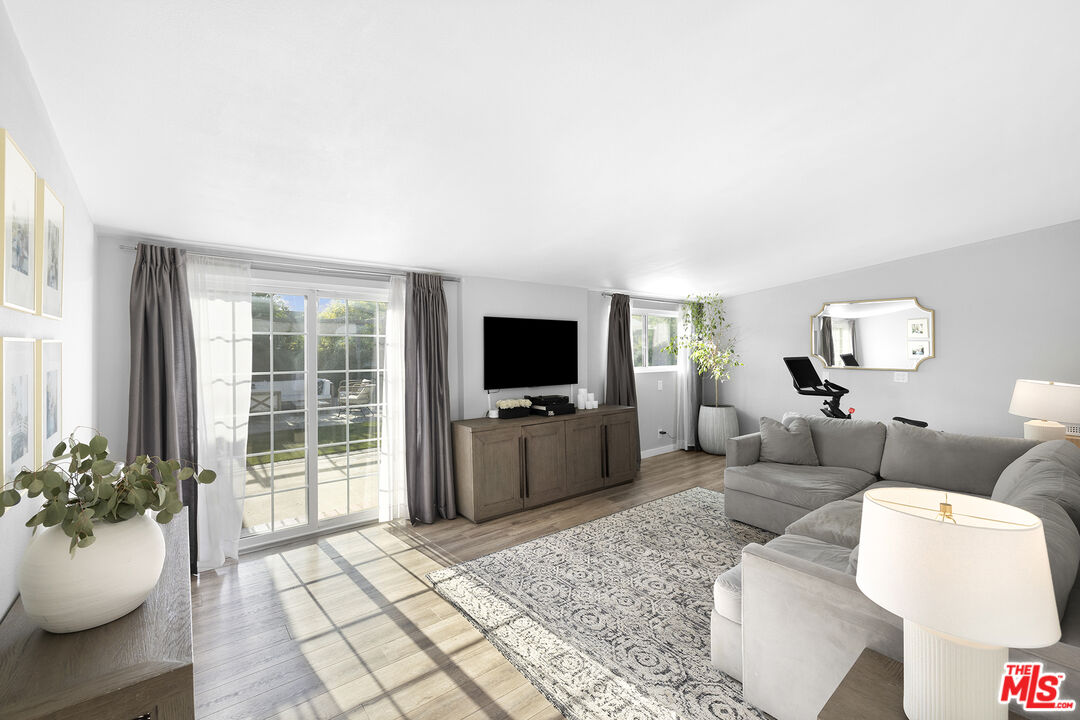 6521 Balcom Avenue Reseda, CA 91335 - Photo 13 of 35 a living room with furniture and a flat screen tv