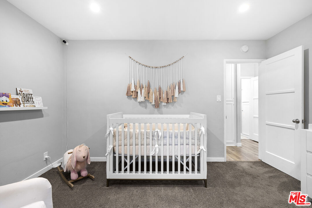 6521 Balcom Avenue Reseda, CA 91335 - Photo 18 of 35 a bedroom with a bed and a window